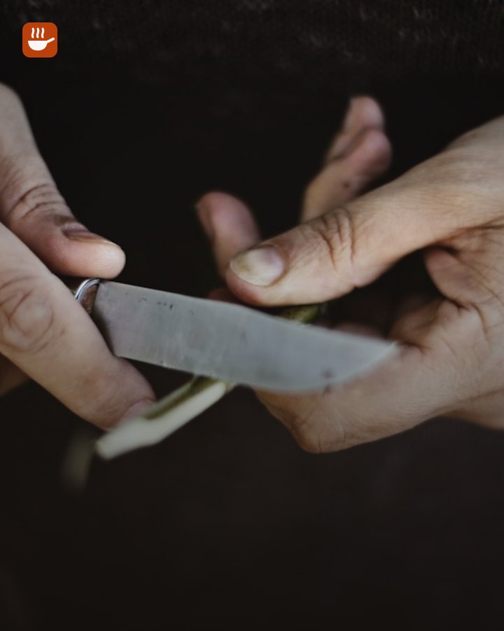 Sharpening a chef’s knife on a whetstone